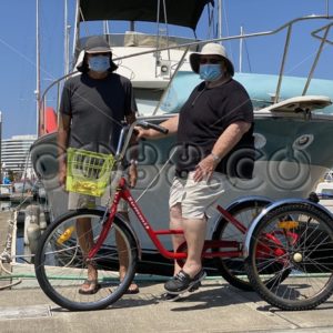 A Female Senior Citizen keeping Fit during the Pandemic by Riding her Red Trike in a small Marina - CO88.co