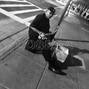 A Jazz Performing Street Musician sitting on a Milk Crate at Night near Oracle Park taking a Break - CO88.co