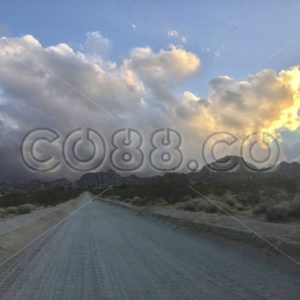 Hitting the Empty Desert Dirt Road On the Way to Joshua Tree National Park with View of Gold Clouds - CO88.co