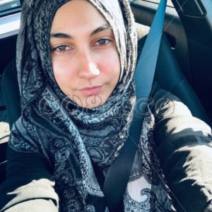 Portrait of Young Muslim Woman in Hijab and Modern Black Abaya Wearing Seat Belt while Driving a Car - CO88.co