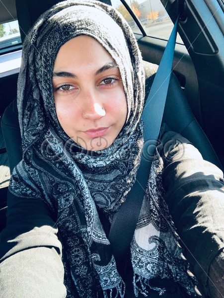 Portrait of Young Muslim Woman in Hijab and Modern Black Abaya Wearing Seat Belt while Driving a Car - CO88.co